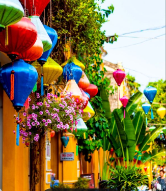 Women exploring lantern-lit streets in Hoi An, Vietnam — Wander Beyond Co group tour